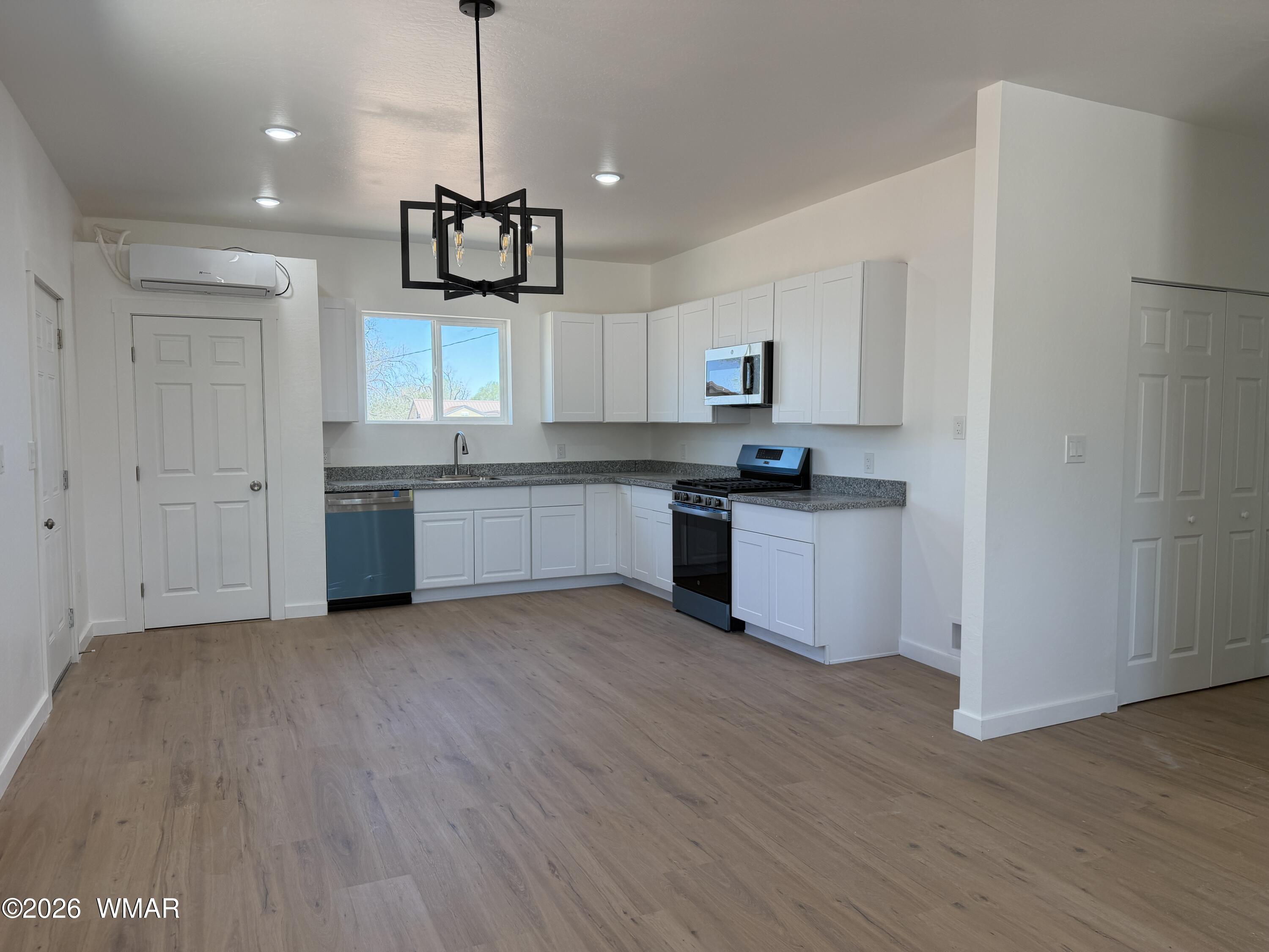 731 Tori Circle Springerville, AZ 85938 - Photo 3 of 19 a kitchen with stainless steel appliances granite countertop a refrigerator a sink dishwasher a stove and white countertops with wooden floor