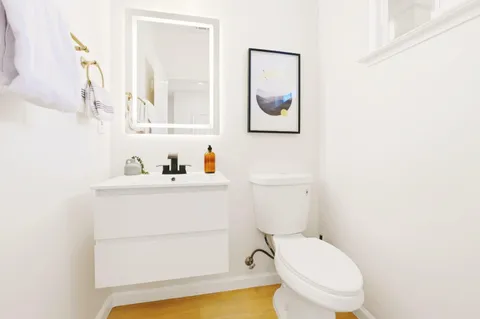 a white toilet sitting next to a bathroom sink