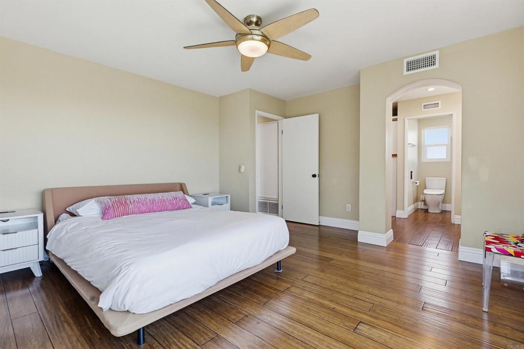 2756 Southampton Road Carlsbad, CA 92010 - Photo 36 of 40 a bedroom with a bed and wooden floor