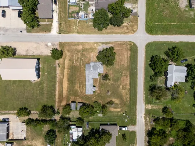 an aerial view of a residential houses with outdoor space