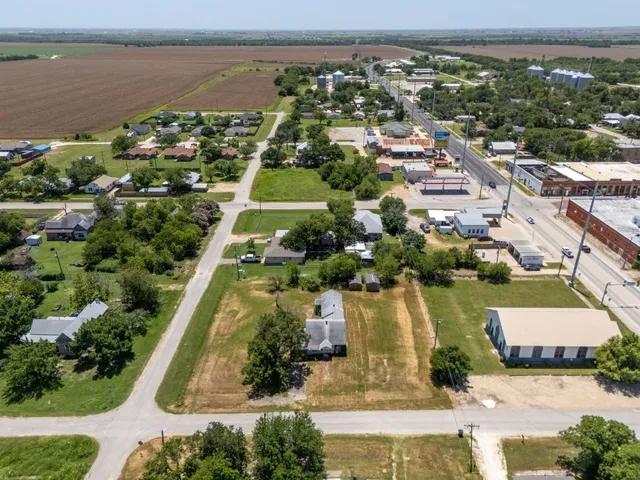 an aerial view of residential houses with outdoor space