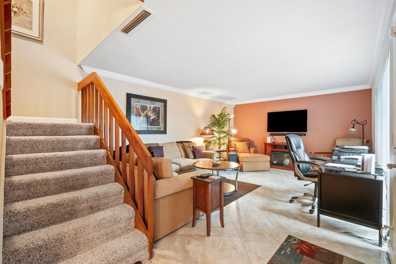 825 Center Street, Unit 13B Jupiter, FL 33458 - Photo 13 of 39 a living room with furniture and a flat screen tv