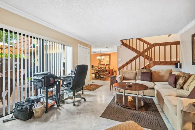 a living room with furniture a rug and a window