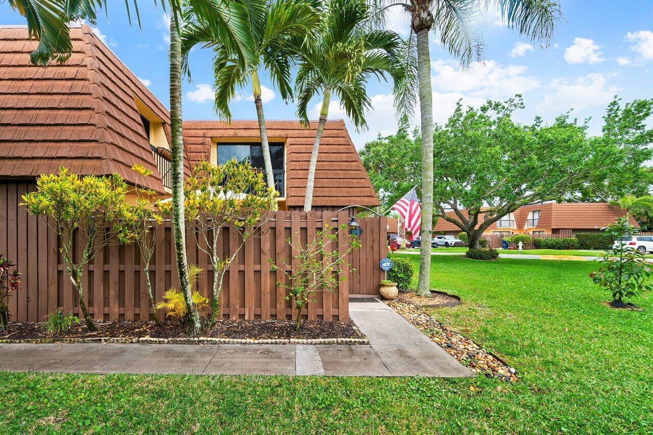 825 Center Street, Unit 13B Jupiter, FL 33458 - Photo 2 of 39 a front view of a house with garden