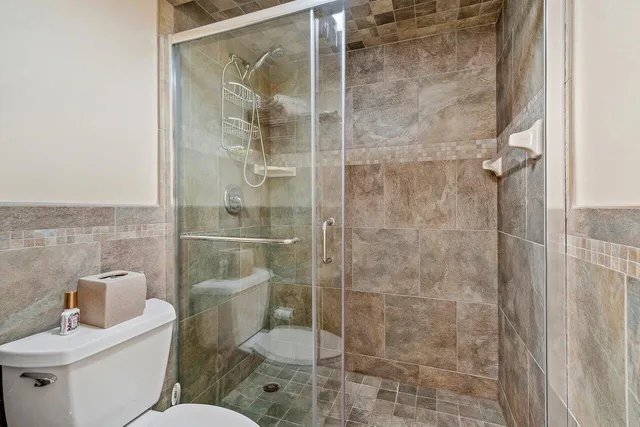 a bathroom with a toilet and shower