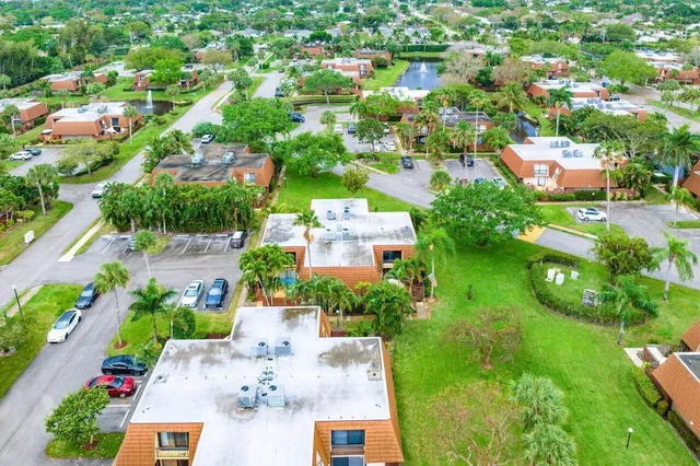 an aerial view of residential houses with outdoor space and street view