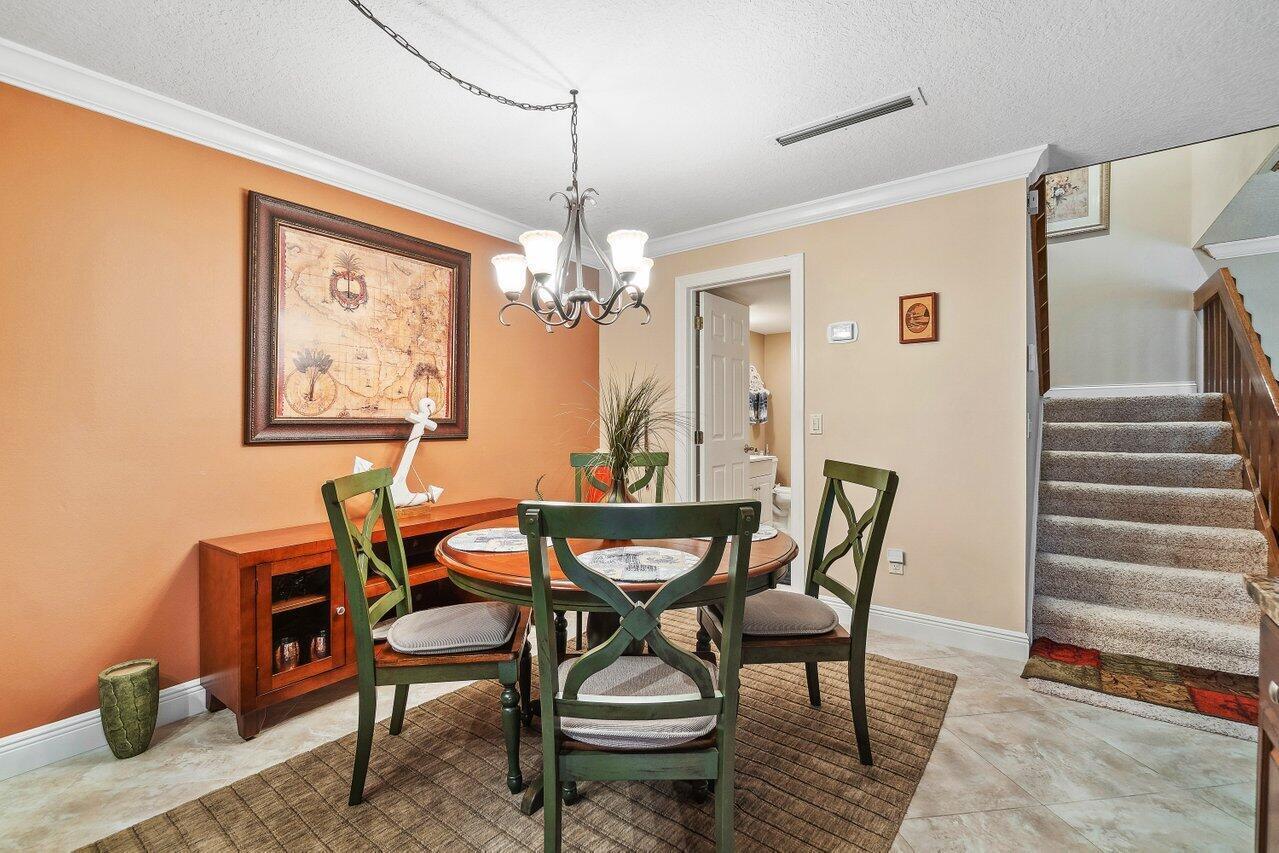 825 Center Street, Unit 13B Jupiter, FL 33458 - Photo 8 of 39 a dining room with furniture and window