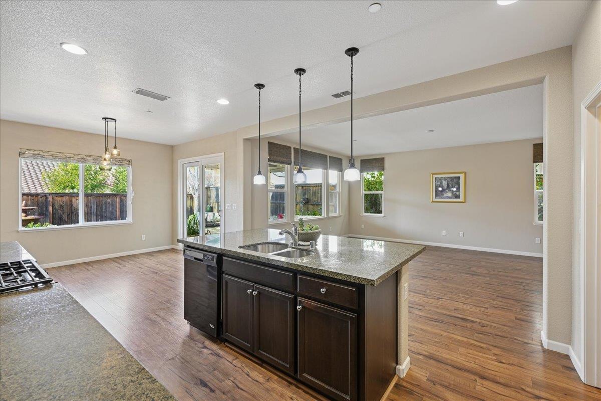 706 Wagon Trail Way Rocklin, CA 95765 - Photo 19 of 61 a kitchen with granite countertop a sink and window
