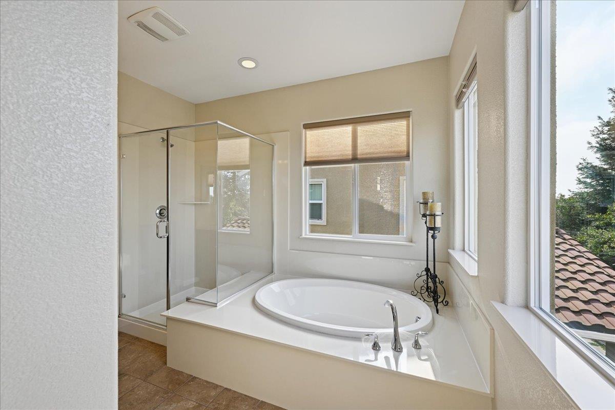 706 Wagon Trail Way Rocklin, CA 95765 - Photo 40 of 61 a bathroom with a granite countertop tub sink a mirror and a shower