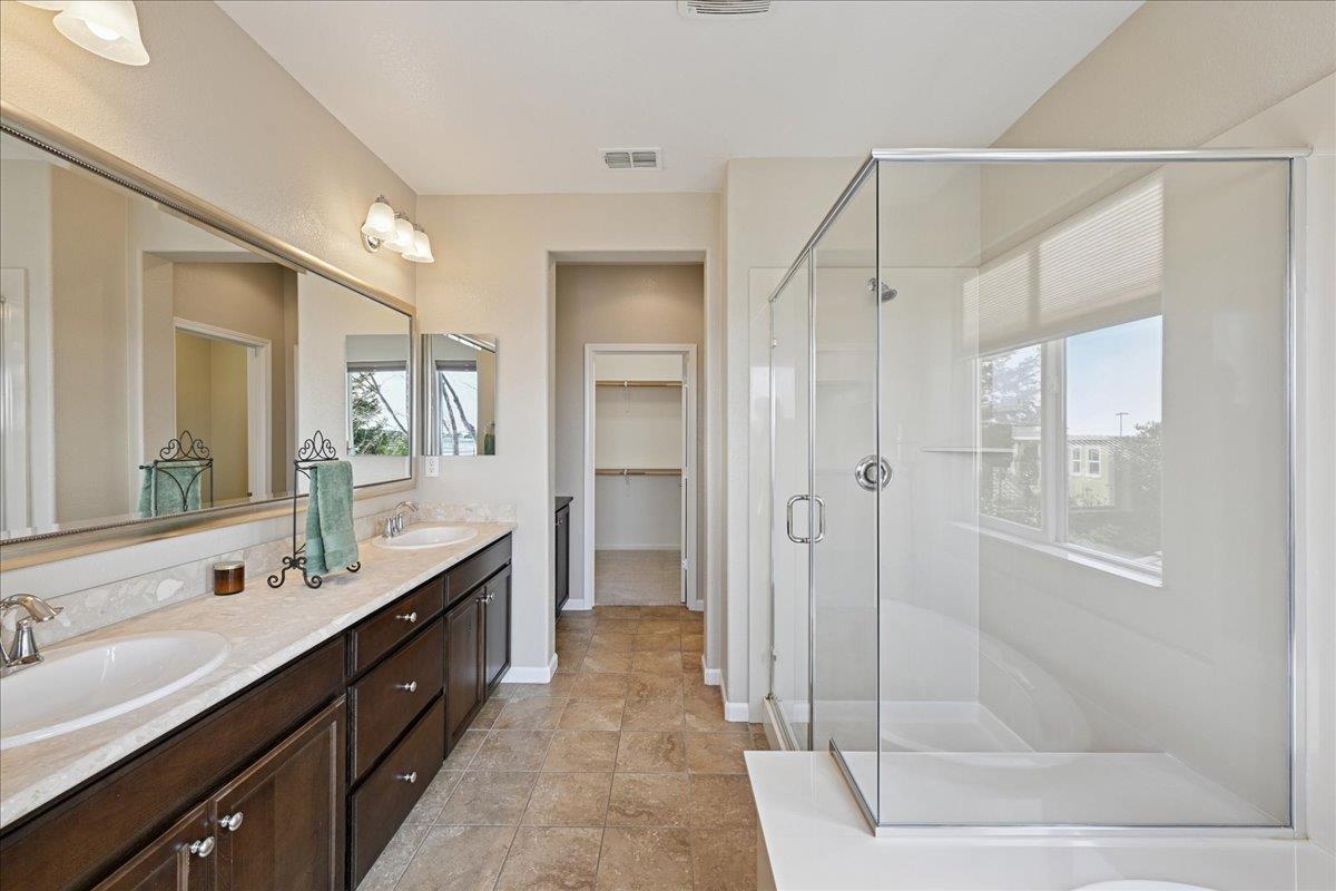 706 Wagon Trail Way Rocklin, CA 95765 - Photo 41 of 61 a spacious bathroom with a shower sink and mirror