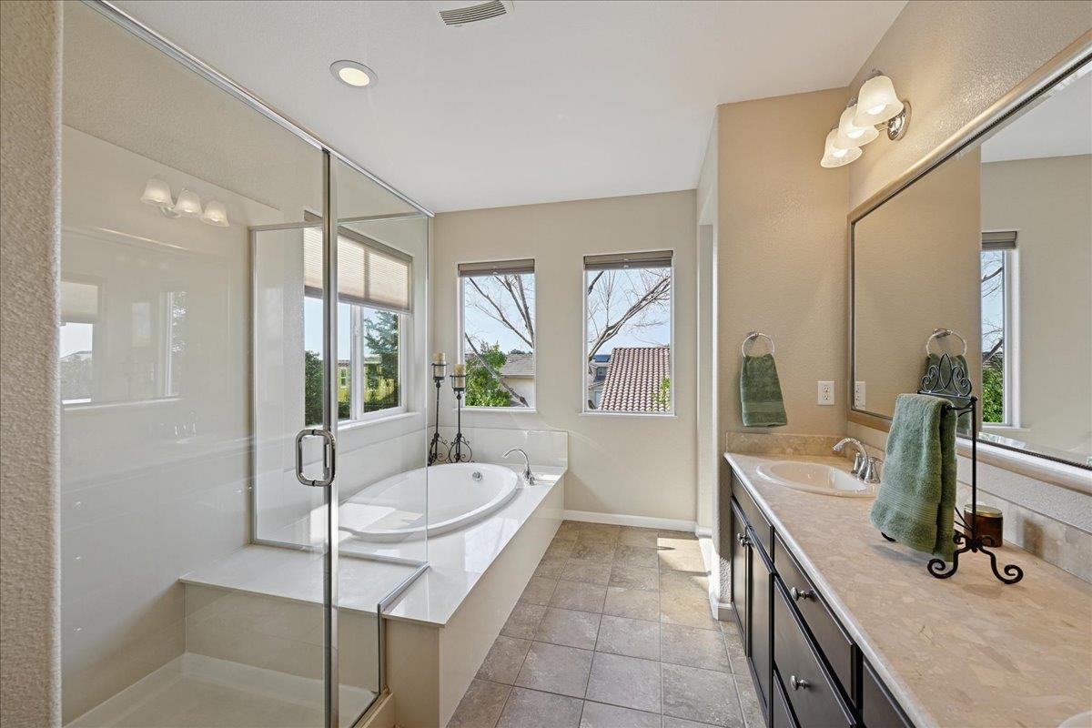 706 Wagon Trail Way Rocklin, CA 95765 - Photo 45 of 61 a bathroom with a tub sink and mirror