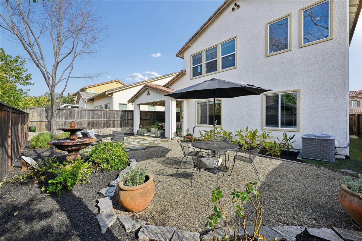706 Wagon Trail Way Rocklin, CA 95765 - Photo 52 of 61 a view of a patio with table and chairs potted plants and large tree
