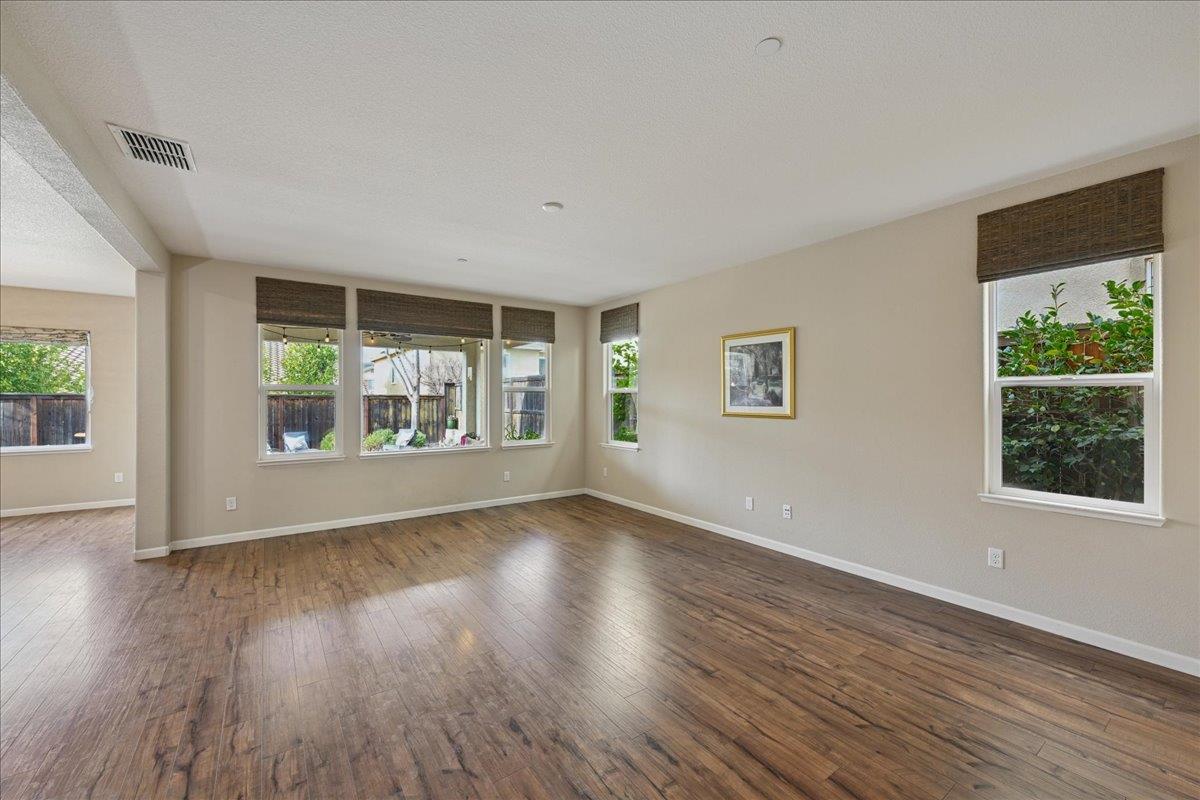 706 Wagon Trail Way Rocklin, CA 95765 - Photo 9 of 61 a view of an empty room with wooden floor and a window