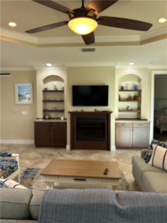 8756 Bellano Court, Unit 1104 Naples, FL 34119 - Photo 6 of 32 Great room with fireplace & bookcases
