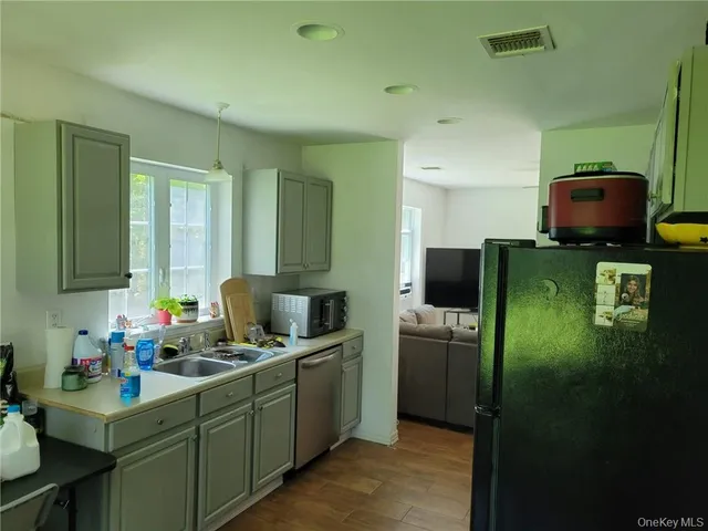 a kitchen with refrigerator and window