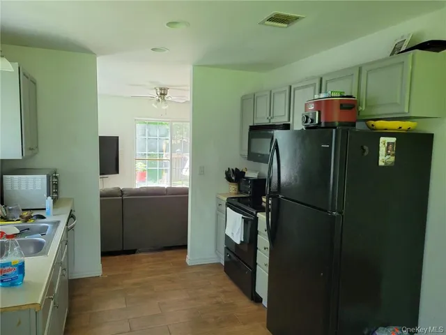 a view of a dining room with furniture a potted plant and a potted plant