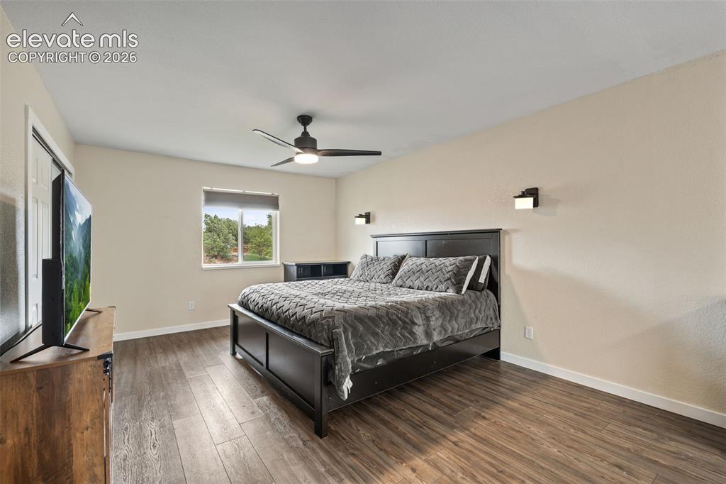 125 Diamond E Road Fountain, CO 80817 - Photo 16 of 43 a bedroom with a bed and a flat screen tv