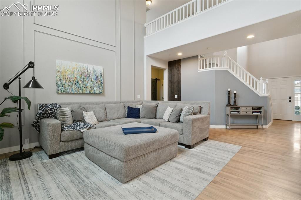 12912 Fishers Island Road Peyton, CO 80831 - Photo 12 of 45 a living room with furniture and a wooden floor