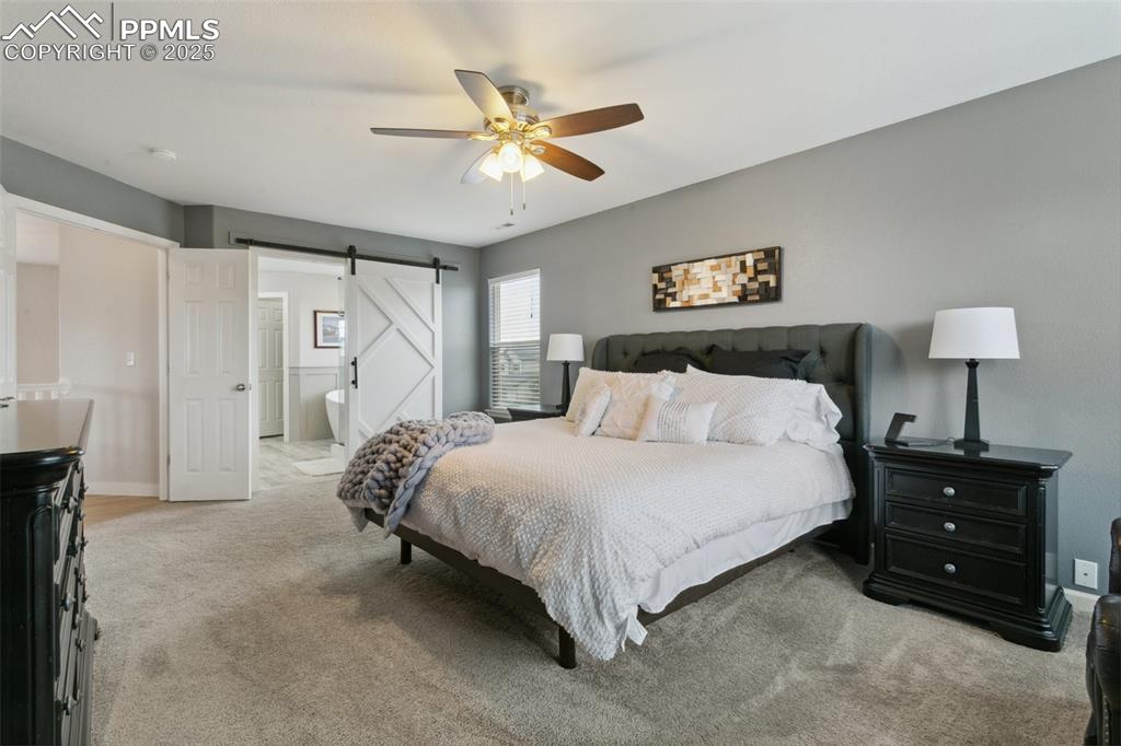 12912 Fishers Island Road Peyton, CO 80831 - Photo 16 of 45 a bedroom with a bed and a lamp on dresser