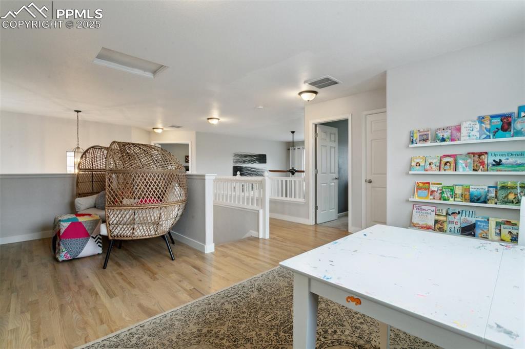 12912 Fishers Island Road Peyton, CO 80831 - Photo 22 of 45 a living room with hard wood flooring and furniture