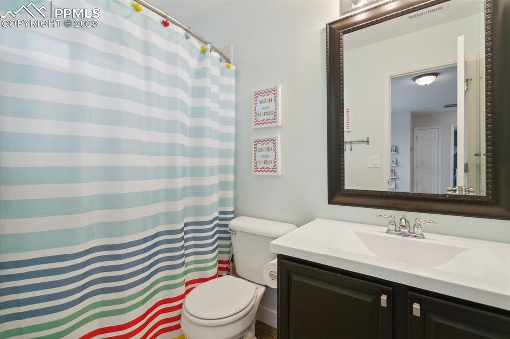 12912 Fishers Island Road Peyton, CO 80831 - Photo 25 of 45 a bathroom with a sink toilet and shower