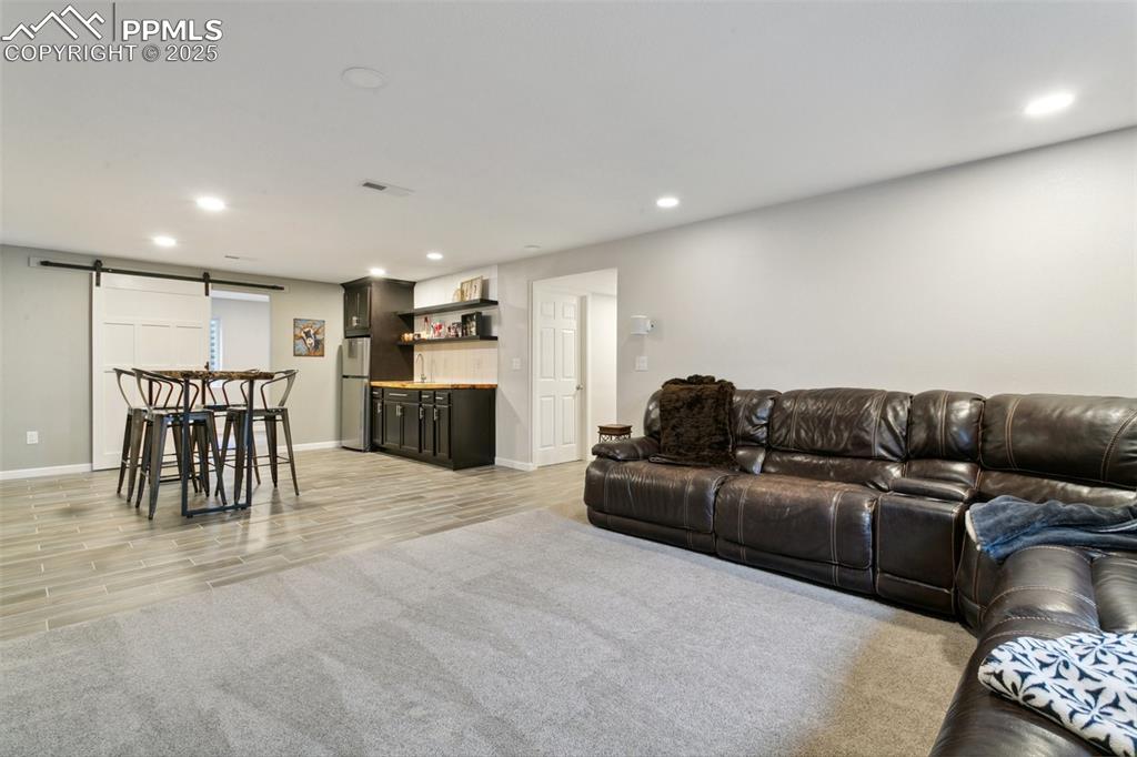 12912 Fishers Island Road Peyton, CO 80831 - Photo 28 of 45 a living room with furniture and kitchen view