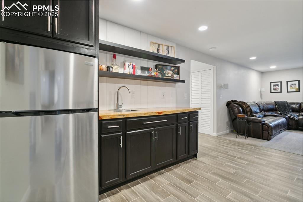 12912 Fishers Island Road Peyton, CO 80831 - Photo 32 of 45 a kitchen with stainless steel appliances granite countertop a refrigerator a stove and a refrigerator