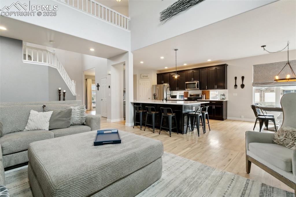 12912 Fishers Island Road Peyton, CO 80831 - Photo 10 of 45 a living room with furniture and kitchen view