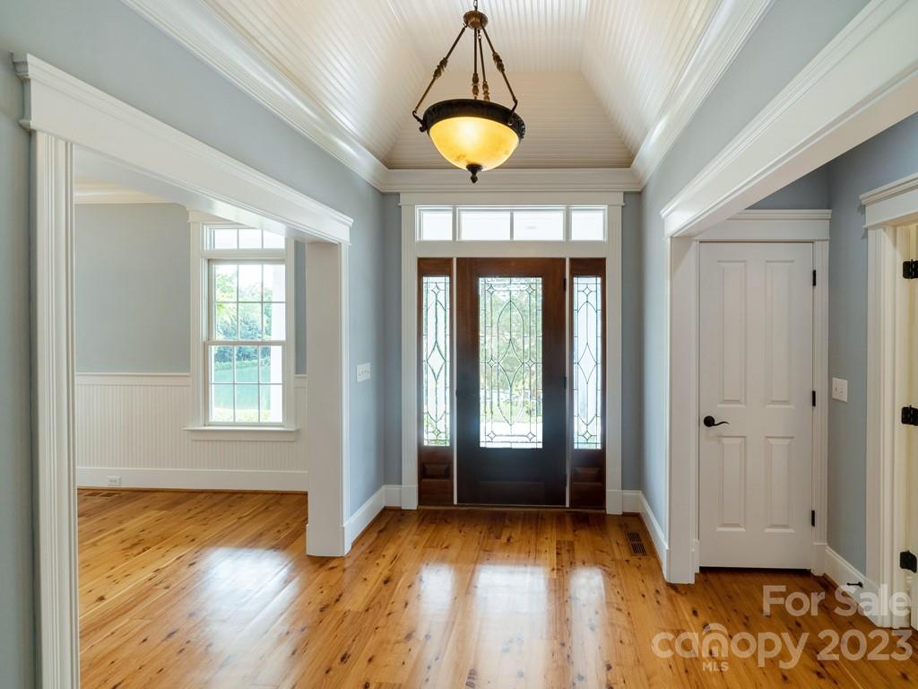 14707 June Washam Road Davidson, NC 28036 - Photo 12 of 48 a view of an empty room with window and wooden floor