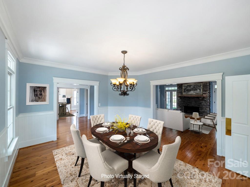 14707 June Washam Road Davidson, NC 28036 - Photo 13 of 48 a view of a dining room with furniture and wooden floor