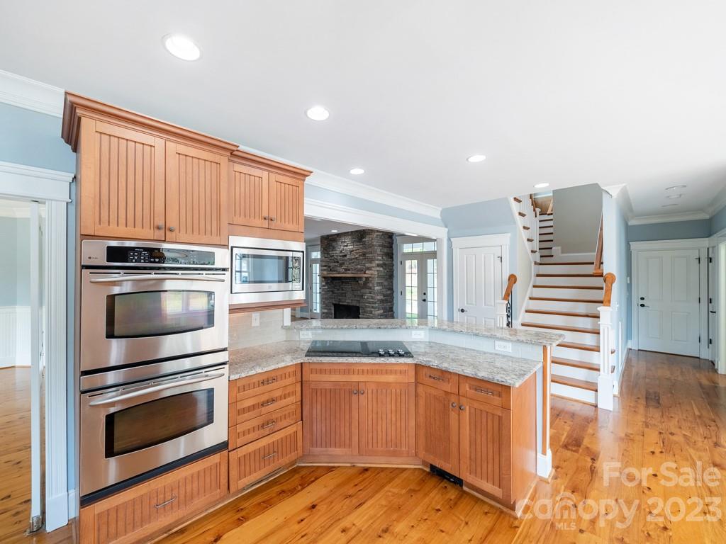 14707 June Washam Road Davidson, NC 28036 - Photo 19 of 48 a kitchen with granite countertop a stove and cabinets