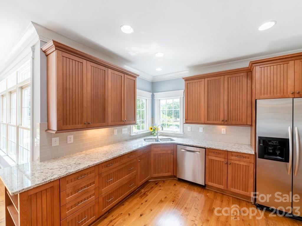 14707 June Washam Road Davidson, NC 28036 - Photo 20 of 48 a kitchen with a sink a refrigerator and window