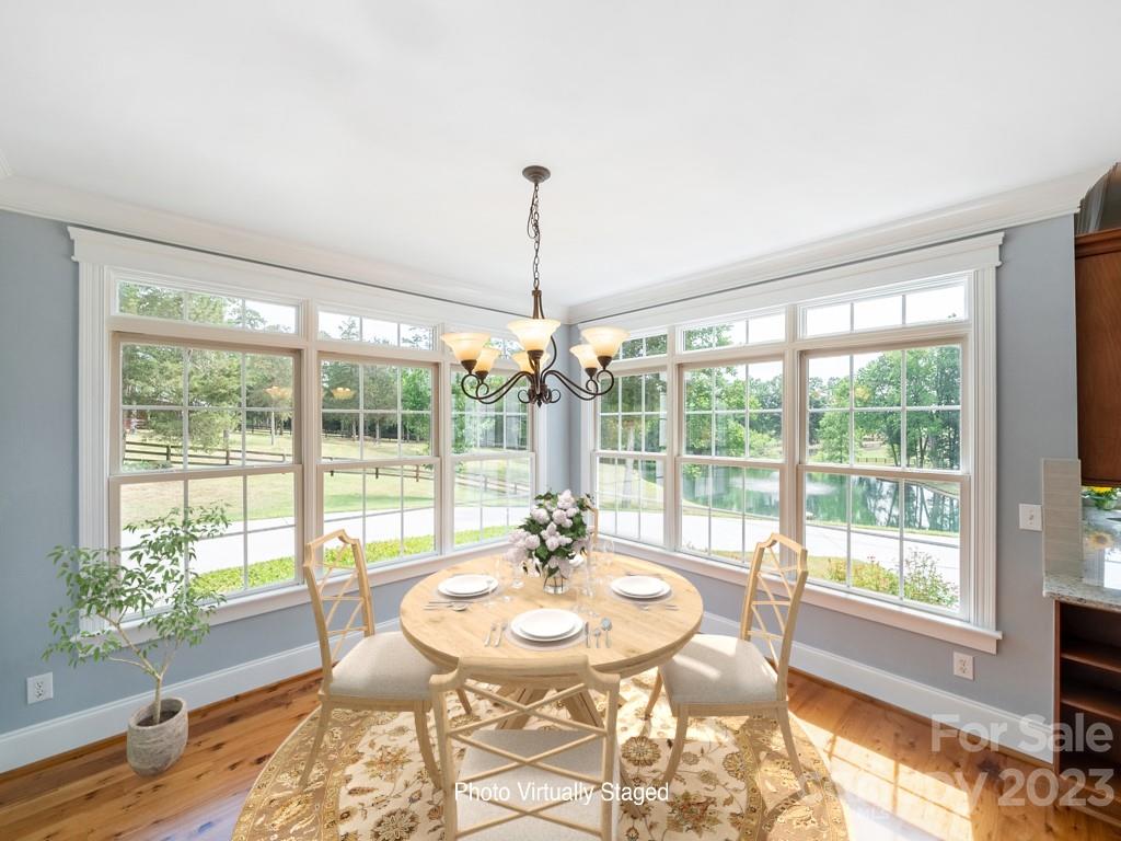 14707 June Washam Road Davidson, NC 28036 - Photo 21 of 48 a view of a dining room with furniture wooden floor and a chandelier
