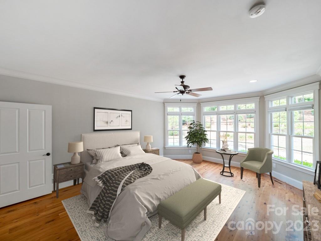 14707 June Washam Road Davidson, NC 28036 - Photo 22 of 48 a spacious bedroom with a bed a couch and large window