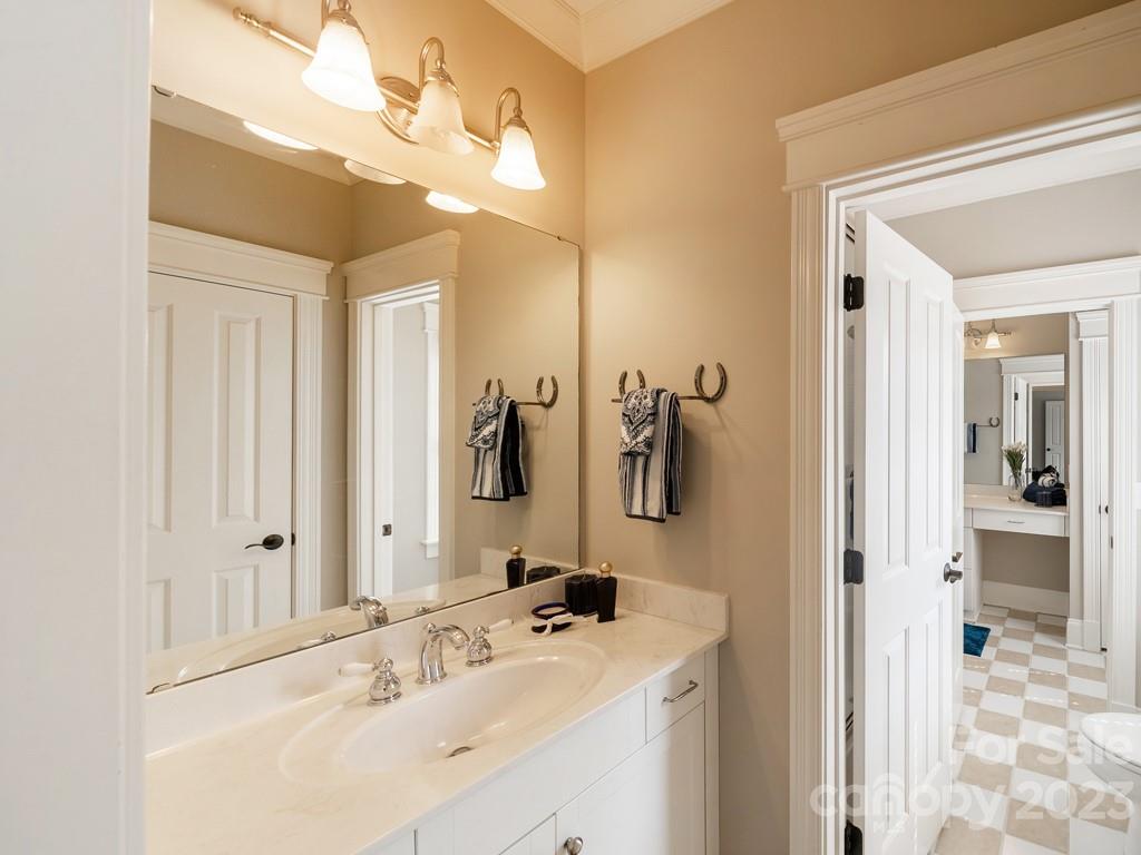 14707 June Washam Road Davidson, NC 28036 - Photo 26 of 48 a bathroom with a sink vanity and mirror