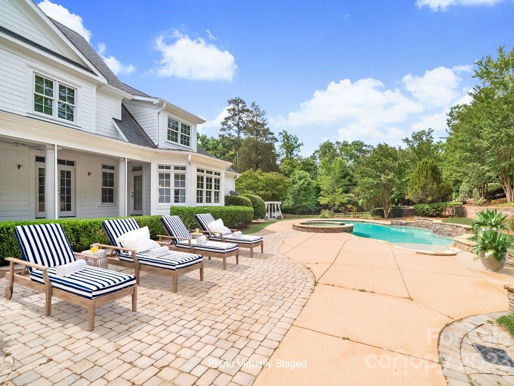 14707 June Washam Road Davidson, NC 28036 - Photo 30 of 48 a view of a patio with couches table and chairs and potted plants