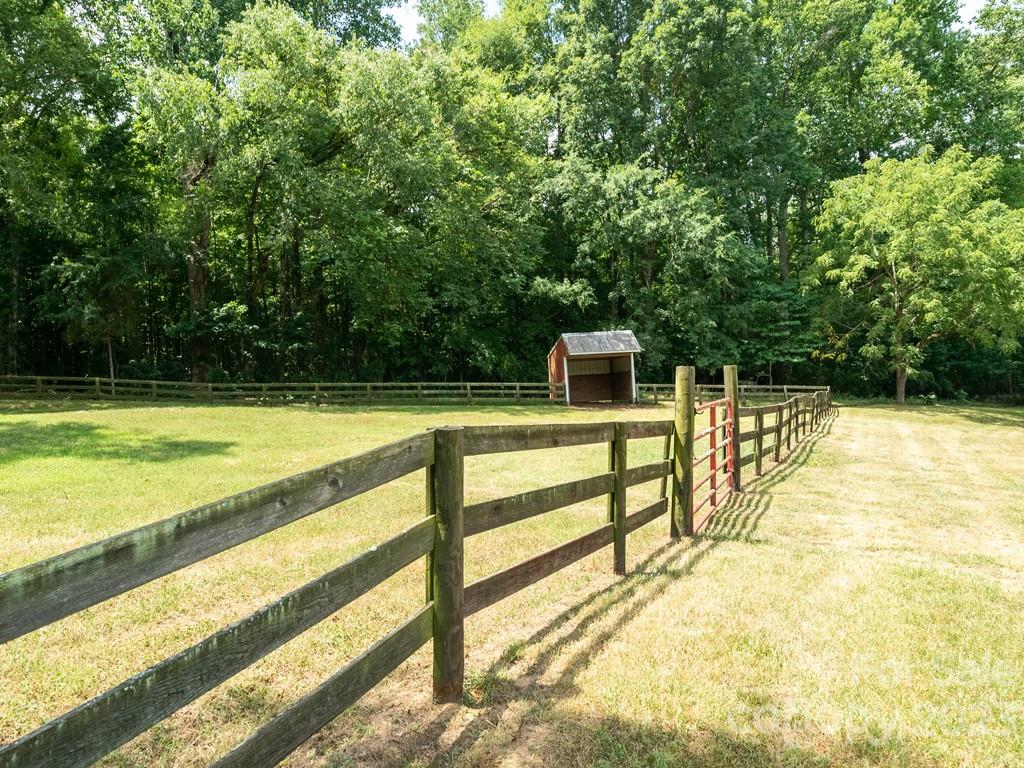 14707 June Washam Road Davidson, NC 28036 - Photo 6 of 48 a view of swimming pool with a small yard
