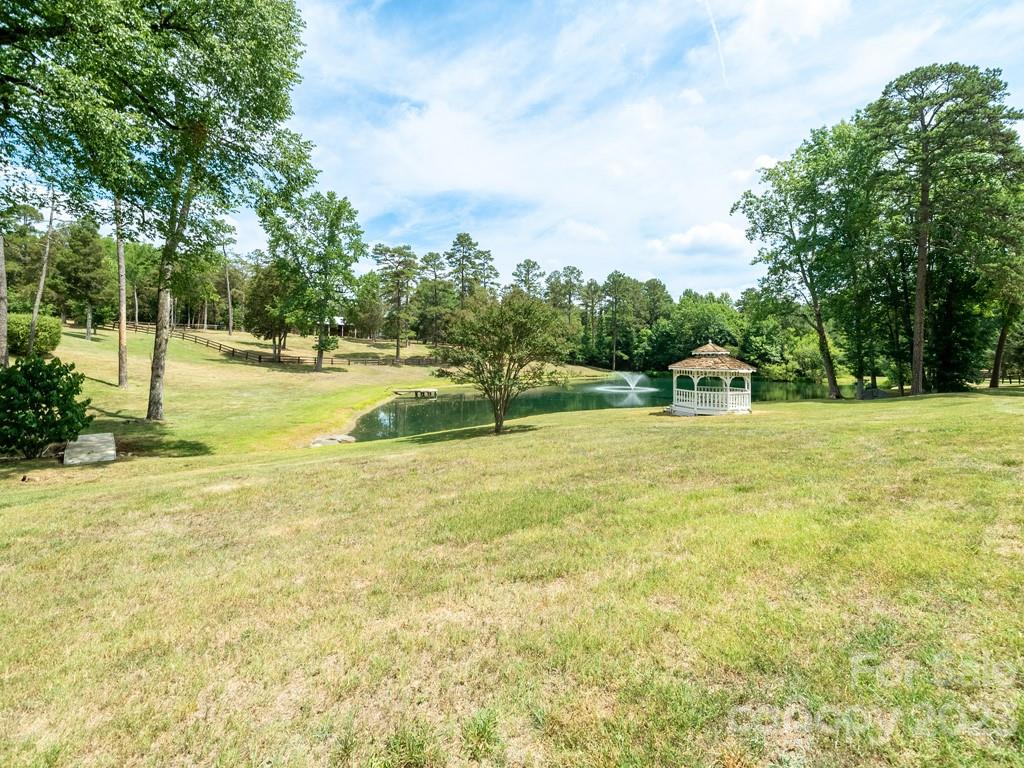 14707 June Washam Road Davidson, NC 28036 - Photo 8 of 48 a view of a swimming pool with a yard