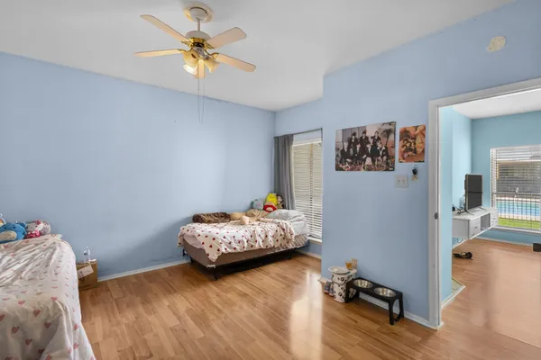 a bedroom with bed and a chandelier