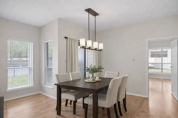 a view of a dining room with furniture window and wooden floor