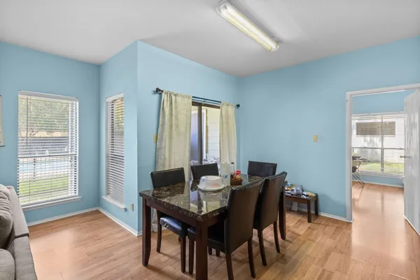a dining room with furniture and wooden floor