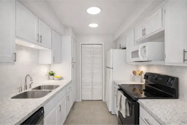 a kitchen that has a sink and a stove