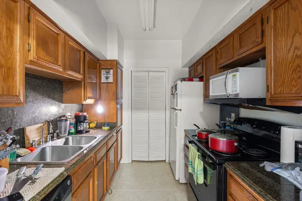 a kitchen with stainless steel appliances granite countertop a stove and a refrigerator