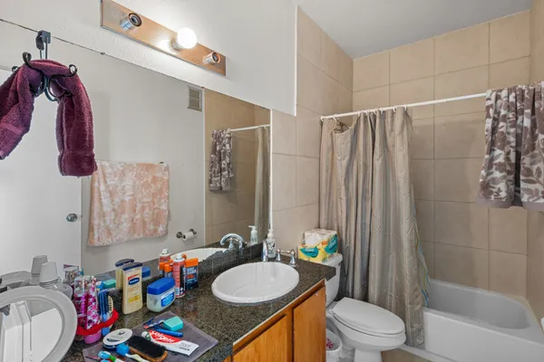 a bathroom with a sink vanity mirror and toilet
