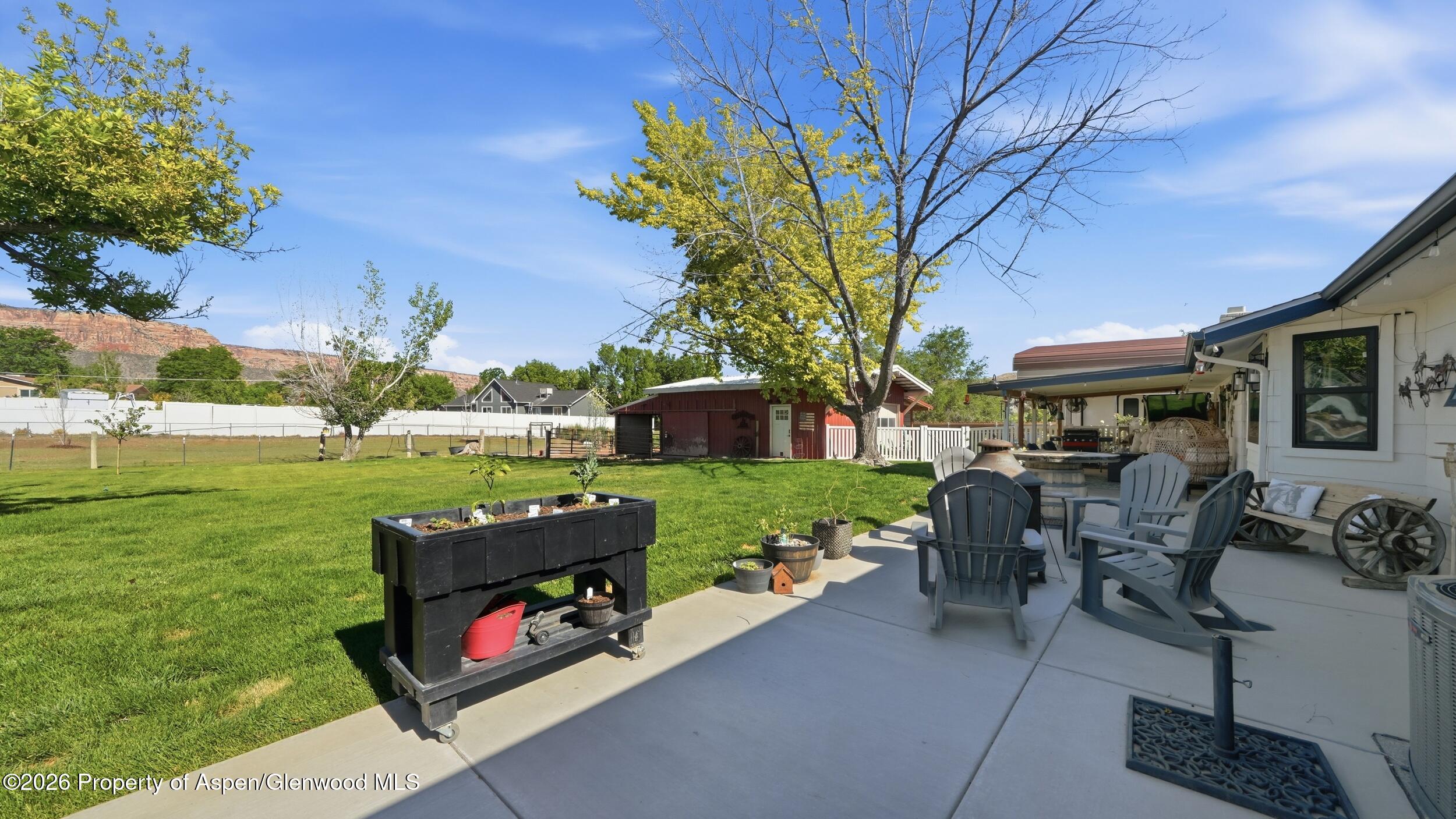 445 South Camp Road Grand Junction, CO 81507 - Photo 29 of 37 a view of a patio with table and chairs potted plants and a large tree