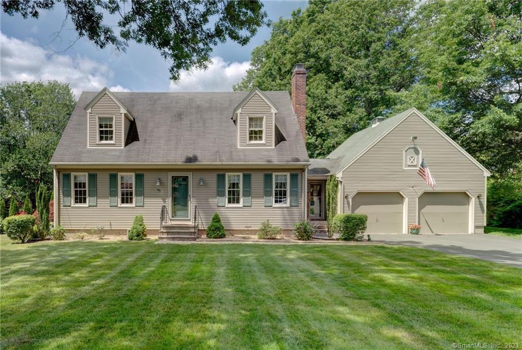 630-4 4 Rod Road Berlin, CT 06037 - Photo 1 of 1 a front view of a house with a yard and trees
