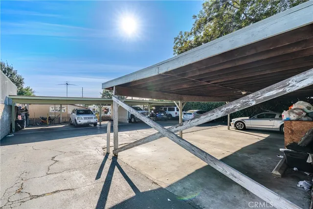 a view of a patio with table and chairs with wooden floor and fence