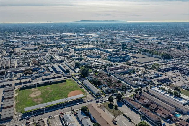 an aerial view of a house with swimming pool and outdoor seating