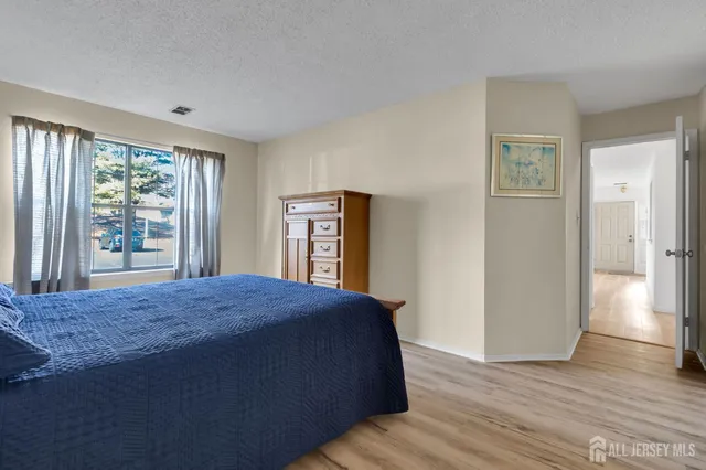 a living room with a bed and a window