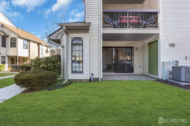 a street sign under a large tree